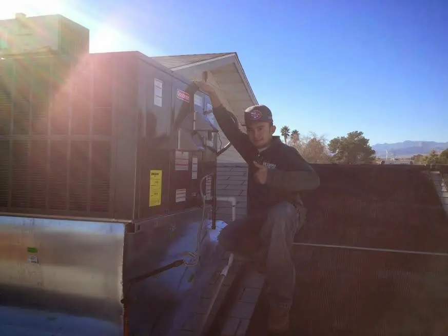 HVAC technician performing Air Duct Repair on a rooftop unit in Pike Creek Valley